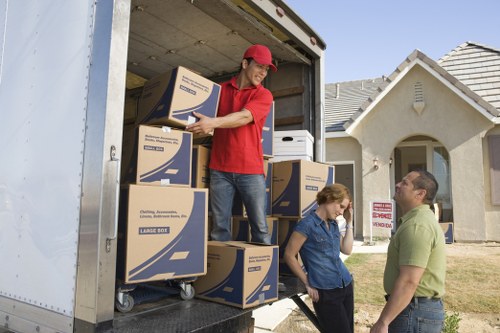Professional movers handling office furniture and equipment