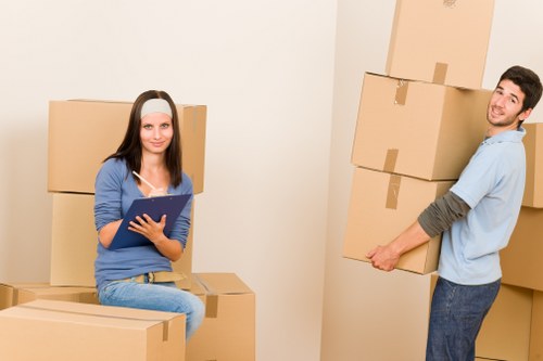 Compact removal service preparing items for transport in Camden