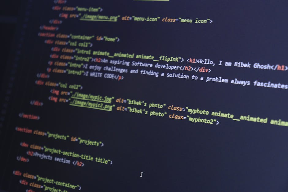 Photograph of a computer screen displaying lines of HTML code with colored syntax highlighting, including tags, attributes, and image file links. The code is displayed on a dark background, and the sc